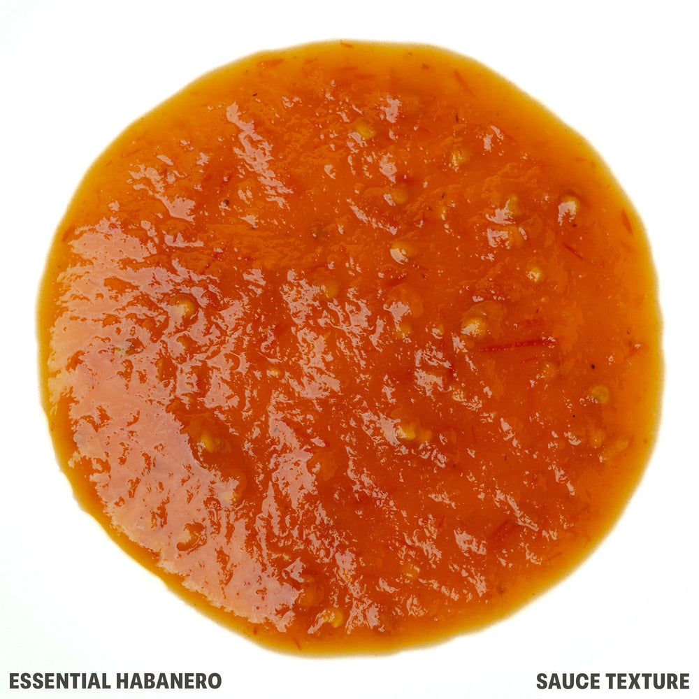 A top-down circular view of a thick, glossy orange-red habanero sauce texture on a white background, with text reading 'ESSENTIAL HABANERO' and 'SAUCE TEXTURE' at the bottom.